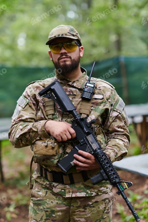 Preview: Elite soldier exudes focused determination and readiness, geared up for a perilous military
