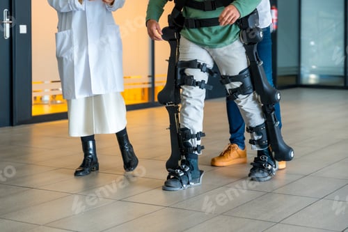 Preview: exoskeleton, female doctor with device walking disabled person with robotic skeleton rehabilitation