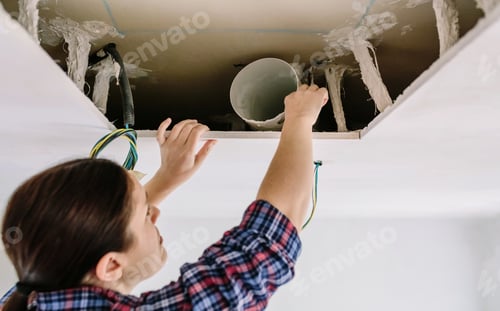 Preview: Woman placing tube for kitchen hood installation