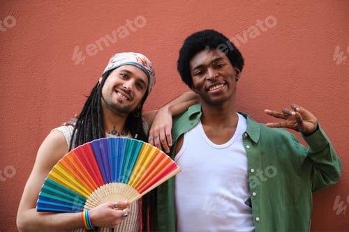 Preview: Two friends showing their support for LGBT rights with a rainbow fan