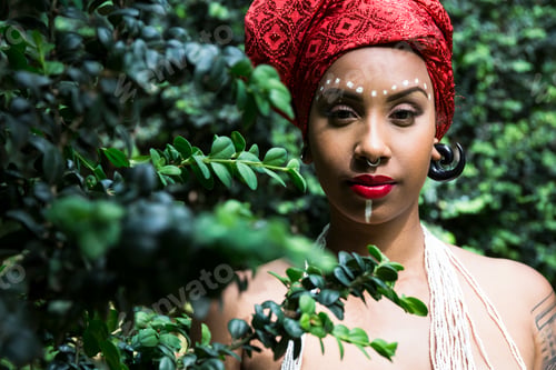 Preview: Portrait of young woman with piercings wearing traditional Brazilian headgear