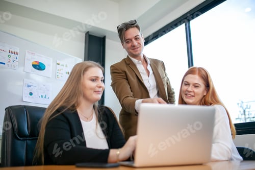 Preview: business team colleagues talking at work share ideas with laptop.