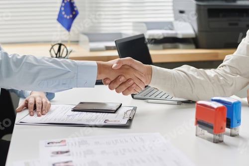 Preview: Visa center employee shaking hands with visitor