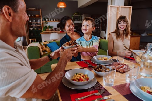 Preview: Family and friends reunion at home. Happy multigenerational family enjoying meal together at home