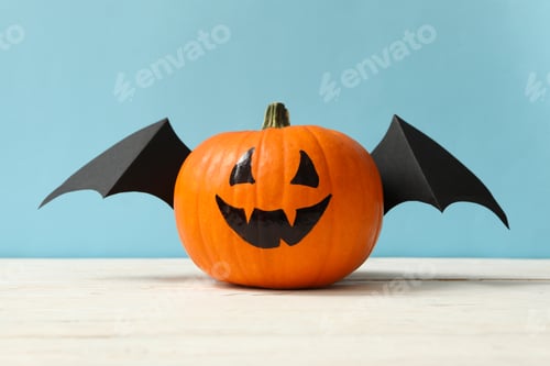 Preview: Pumpkin with smile and wings on blue background