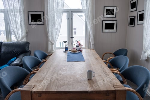 Preview: Interior wooden dining table with chairs and blank picture frame on winter