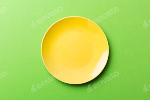 Preview: Top view of isolated of colored background empty round yellow plate