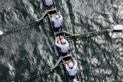 Preview: Overhead view of female crew racers rowing in an octuple racing shell, an eights team.