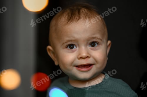 Preview: Portrait of a one-year-old baby, the child plays with a glowing garland