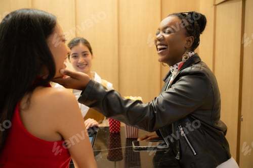 Preview: Asian ticket seller at the box office with the service of selling movie tickets to movie audiences