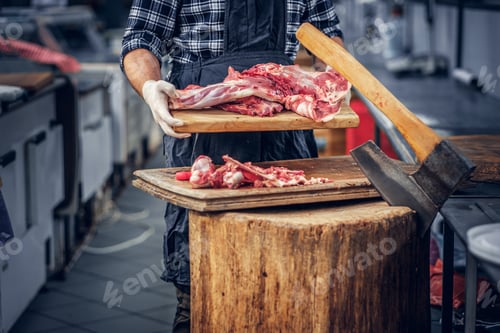 Preview: Bearded butcher serving fresh cut meat.
