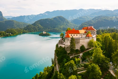 Preview: Aerial view of mediaeval Bled castle on the cliff of the mountain under lake Bled with turquoise
