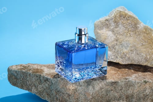 Vista previa: Stylish presentation of luxury men`s perfume on stones against light blue background