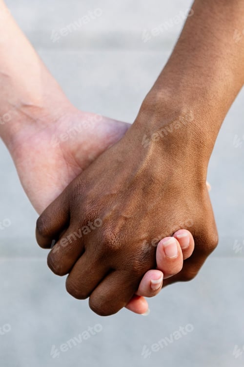 Preview: Diversity concept with african woman holding hand with caucasian female