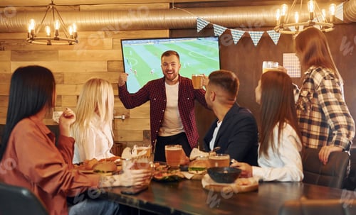 Preview: Against TV. Group of young friends sitting together in bar with beer