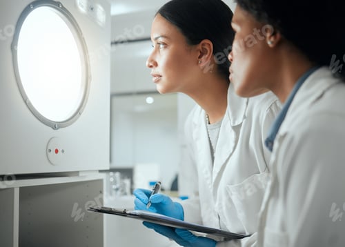 Preview: Shot of two female scientists looking through a door waiting for results