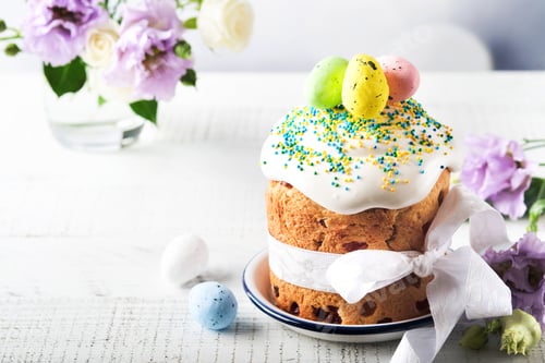 Preview: Traditional Easter sweet bread or cakes with white icing and sugar decor and quail eggs over white w