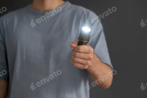 Preview: a man holding an electric light torch in the dark space
