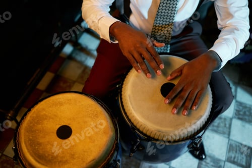 Preview: Black Male Drummer Playing Rhythm on Congas in Jazz Club
