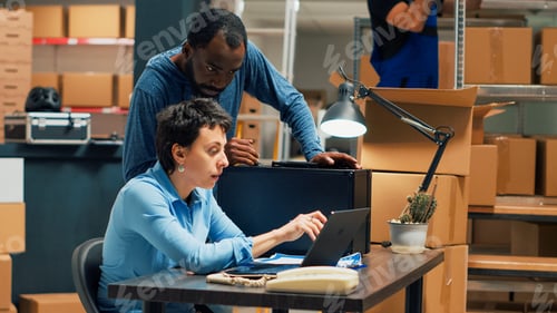 Preview: Employees team planning storage shipment on laptop