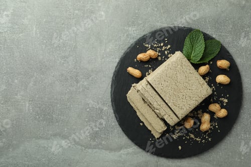 Preview: Concept of tasty food with halva on gray textured background