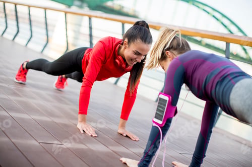 Preview: Women doing plank on riverside