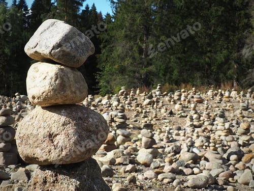 Preview: A lot of pyramids made of natural stone in a sunny glade