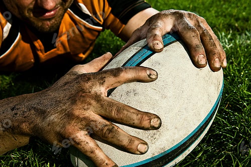Preview: Rugby player claiming the ball on a grassy field