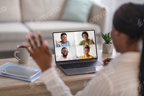 Preview: Young black woman or teacher, waving hand, communicating with students or workers online