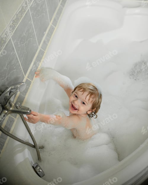 Preview: happy child bathes in a bubble bath