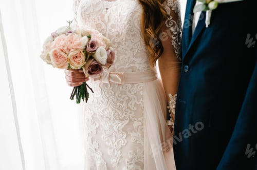 Preview: The bride and groom with a wedding bouquet, holding on hands and standing on wedding ceremony