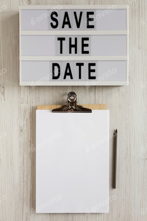 Preview: 'Save the date' words on a modern board, clipboard with blank sheet of paper.