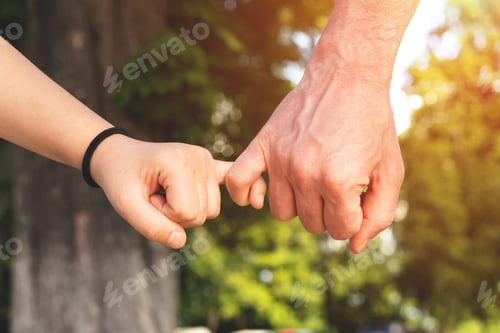 Preview: Father and child daughter hold on with their little fingers