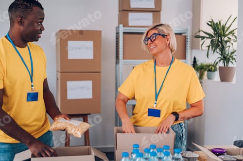 Preview: Group of multiracial volunteers working in community charity donation center
