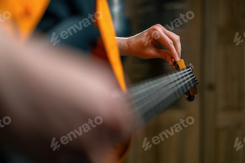Preview: rock performer with electric guitar in recording studio recording playing own track