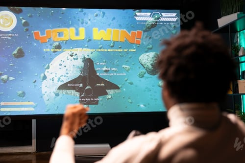 Preview: Gamer excited after winning online multiplayer game match on ultrawide smart TV