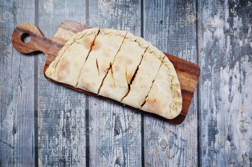 Preview: pizza calzone on a table