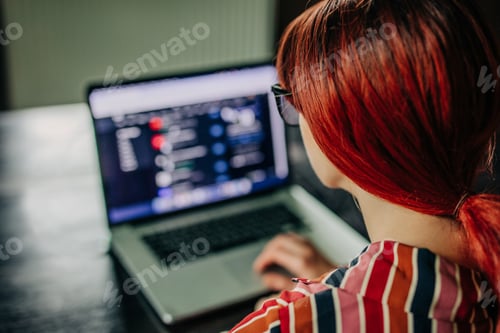 Preview: Redhead European Woman Surfing Internet for a job developer in IT, at Home