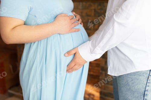 Preview: A pregnant woman's stomach is held by male hands
