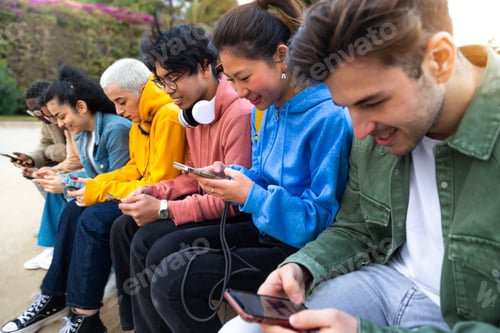 Preview: Diverse teenage college students ignoring each other using smartphone checking social media.