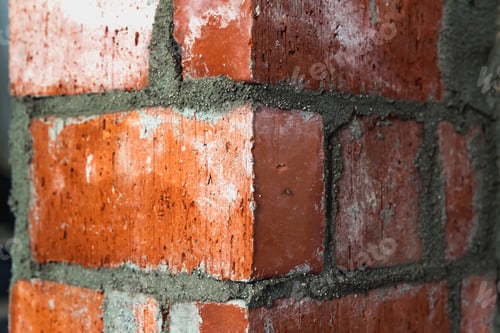 Preview: Close up of bricklaying industrial installing bricks on construction site wall