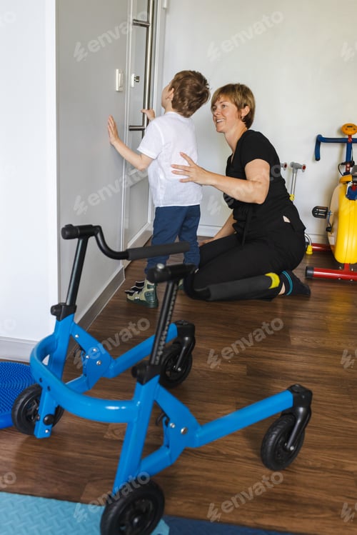Preview: Young boy with cerebral palsy engages in a physical rehabilitation session with a therapist in a