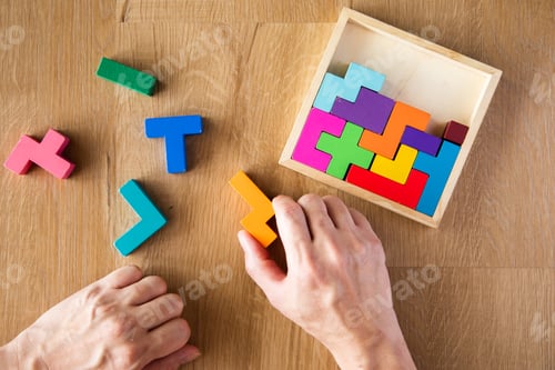 Preview: hand arranging wooden blocks