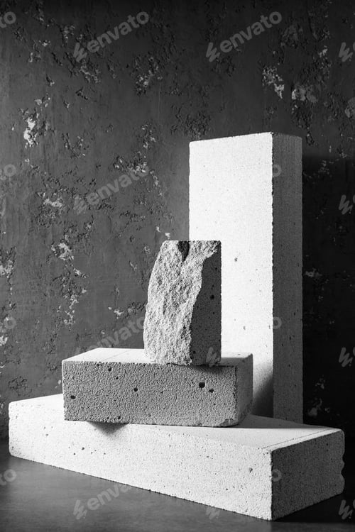 Preview: Aerated concrete block cube or bricks near plaster wall background texture. Construction concept