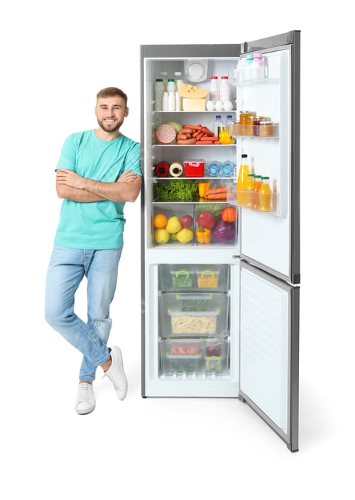 Preview: Young man near open refrigerator on white background