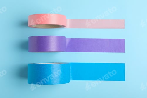Preview: Many rolls of adhesive tape on light blue background, flat lay