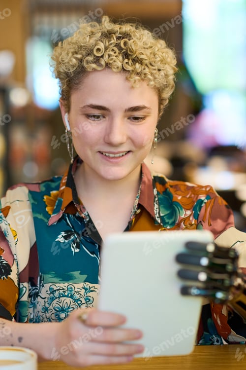 Preview: Happy young woman with myoelectric arm communicating in video chat