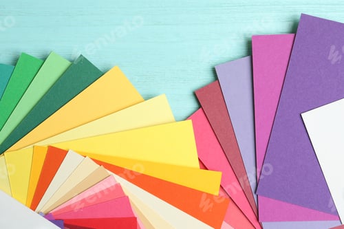 Preview: Color palettes on light blue wooden background, flat lay