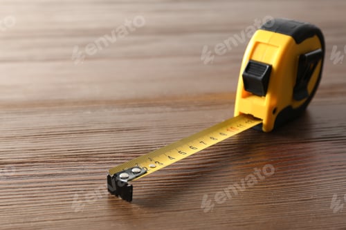Preview: Metal measuring tape on wooden background. Space for text