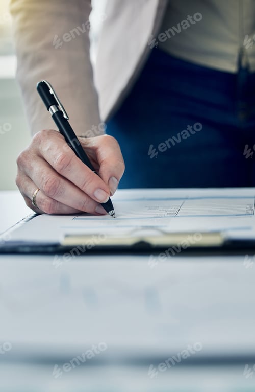 Preview: Woman Writes on Legal Document at Desk